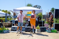 a man and a woman standing in front of a tent